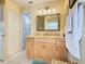 Well-lit bathroom with granite countertop vanity and linen storage at 1515 Oak Hill Trl, Kissimmee, FL 34747