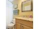 Bathroom featuring a granite-topped vanity, a toilet, and a shower with a curtain at 1515 Oak Hill Trl, Kissimmee, FL 34747