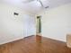 Bedroom featuring wood floors, a ceiling fan, a double door closet, and neutral walls at 1515 Oak Hill Trl, Kissimmee, FL 34747
