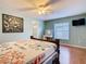 Comfortable bedroom with a ceiling fan, vanity, and access to the bathroom at 1515 Oak Hill Trl, Kissimmee, FL 34747