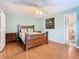 Bedroom features a wooden bed frame, a ceiling fan, and a bathroom entrance at 1515 Oak Hill Trl, Kissimmee, FL 34747