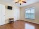 Bedroom features wood floors, a window with blinds, a ceiling fan and a double door closet at 1515 Oak Hill Trl, Kissimmee, FL 34747