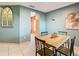 Dining room with a wooden table set for four, complemented by stylish decor and neutral paint at 1515 Oak Hill Trl, Kissimmee, FL 34747
