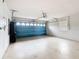 The garage features a blue garage door and white painted walls at 1515 Oak Hill Trl, Kissimmee, FL 34747