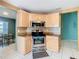 Cozy kitchen showcases stainless steel appliances, granite countertops, and light wood cabinets at 1515 Oak Hill Trl, Kissimmee, FL 34747