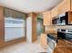 Bright kitchen features modern appliances, granite counters, and a window with natural light at 1515 Oak Hill Trl, Kissimmee, FL 34747