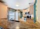 Modern kitchen features stainless appliances, granite countertops, and convenient pass-through to living area at 1515 Oak Hill Trl, Kissimmee, FL 34747