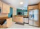 Spacious kitchen with stainless steel appliances and granite countertops overlooking the living area at 1515 Oak Hill Trl, Kissimmee, FL 34747