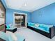 Enclosed lanai features blue walls, wicker seating, and sliding glass doors to enjoy Florida living at 1515 Oak Hill Trl, Kissimmee, FL 34747