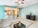 Open-concept living room with tile flooring and breakfast bar into the kitchen at 1515 Oak Hill Trl, Kissimmee, FL 34747