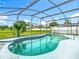 The screened pool is surrounded by a beautiful lawn and lush vegetation, offering a serene escape at 1515 Oak Hill Trl, Kissimmee, FL 34747