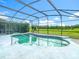 Sparkling pool enclosed with a screen offers backyard views at 1515 Oak Hill Trl, Kissimmee, FL 34747