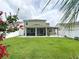 A spacious backyard with a screened-in porch and pergola offers outdoor enjoyment at 15230 Evergreen Oak Loop, Winter Garden, FL 34787