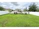 Spacious backyard featuring a lush green lawn, garden beds, and privacy fencing at 15230 Evergreen Oak Loop, Winter Garden, FL 34787