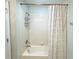 Bathroom featuring a shower/tub combo with tiled walls and decorative shower curtain at 15230 Evergreen Oak Loop, Winter Garden, FL 34787