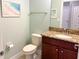 Half bathroom with granite countertop, wood vanity, and contemporary fixtures offering comfort and style at 15230 Evergreen Oak Loop, Winter Garden, FL 34787