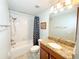 Bathroom featuring a shower/tub combo, a wood vanity with a granite countertop, and modern fixtures at 15230 Evergreen Oak Loop, Winter Garden, FL 34787
