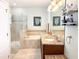 Bathroom features a glass shower, soaking tub, and double vanity with granite countertop at 15230 Evergreen Oak Loop, Winter Garden, FL 34787