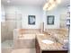 Bathroom features a glass shower, soaking tub, and double vanity with granite countertop at 15230 Evergreen Oak Loop, Winter Garden, FL 34787