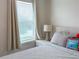 Cozy bedroom featuring hardwood floors, soft lighting, and a comfortable bed by a window, creating a relaxing atmosphere at 15230 Evergreen Oak Loop, Winter Garden, FL 34787