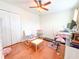 Cozy bedroom with hardwood floors, ceiling fan, and ample natural light, providing a comfortable and functional space at 15230 Evergreen Oak Loop, Winter Garden, FL 34787