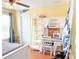 Cheerful bedroom with yellow walls, hardwood floors, and built-in shelving, creating an organized and vibrant atmosphere at 15230 Evergreen Oak Loop, Winter Garden, FL 34787