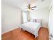 Bright bedroom with hardwood floors, ceiling fan, and a comfortable bed, creating a serene and inviting space at 15230 Evergreen Oak Loop, Winter Garden, FL 34787