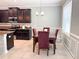 Dining space featuring dark wood table, velvet chairs, and ample natural light at 15230 Evergreen Oak Loop, Winter Garden, FL 34787