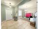 Open entryway showcasing tile flooring, front door, and seamlessly flowing into adjacent living spaces at 15230 Evergreen Oak Loop, Winter Garden, FL 34787