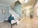 Welcoming entryway with tiled floors, staircase, and stylish decor at 15230 Evergreen Oak Loop, Winter Garden, FL 34787