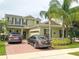 Inviting two story home featuring lush landscaping, solar panels, brick driveway, and a two car garage at 15230 Evergreen Oak Loop, Winter Garden, FL 34787