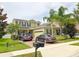 Charming two-story home with manicured lawn and a paved driveway fitting two parked cars at 15230 Evergreen Oak Loop, Winter Garden, FL 34787