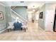 Spacious foyer with staircase, light tile flooring, and bright, welcoming ambiance creating a lasting first impression at 15230 Evergreen Oak Loop, Winter Garden, FL 34787