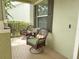 Charming front porch with cozy seating, perfect for relaxing and enjoying the neighborhood views at 15230 Evergreen Oak Loop, Winter Garden, FL 34787