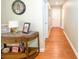 Welcoming hallway boasts hardwood floors and neutral paint, complemented by an elegant console table with decor at 15230 Evergreen Oak Loop, Winter Garden, FL 34787