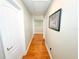 Hallway with hardwood floors, white doors, and a framed picture on the wall at 15230 Evergreen Oak Loop, Winter Garden, FL 34787