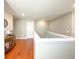 Bright hallway features hardwood floors, neutral paint, and white doors, creating a clean and inviting transition space at 15230 Evergreen Oak Loop, Winter Garden, FL 34787