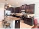 Bright kitchen boasting an island with seating, stainless appliances, and dark cabinetry at 15230 Evergreen Oak Loop, Winter Garden, FL 34787