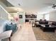 Inviting living room showcasing neutral decor, tile flooring, and seamless flow into the kitchen at 15230 Evergreen Oak Loop, Winter Garden, FL 34787