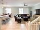 Spacious living room with tile flooring, a comfortable sectional, and modern furnishings at 15230 Evergreen Oak Loop, Winter Garden, FL 34787