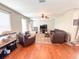 Comfortable living room with hardwood floors, ceiling fan, and ample seating at 15230 Evergreen Oak Loop, Winter Garden, FL 34787