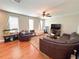 Comfortable living room with hardwood floors, ceiling fan, and ample seating at 15230 Evergreen Oak Loop, Winter Garden, FL 34787