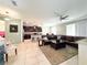 Spacious living room featuring modern kitchen, comfortable seating, and open layout ideal for entertaining and relaxation at 15230 Evergreen Oak Loop, Winter Garden, FL 34787