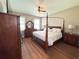 Comfortable main bedroom showcasing hardwood flooring and dark wood furniture at 15230 Evergreen Oak Loop, Winter Garden, FL 34787