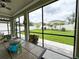 Screened patio with a table and chairs overlooks a beautifully landscaped fenced backyard at 15230 Evergreen Oak Loop, Winter Garden, FL 34787