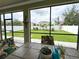 Screened patio features a tile-top table with seating and a peaceful view of the backyard at 15230 Evergreen Oak Loop, Winter Garden, FL 34787