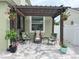 Paver patio with a pergola and outdoor seating area with garden accents at 15230 Evergreen Oak Loop, Winter Garden, FL 34787