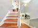 Staircase featuring hardwood steps and white railings, overlooking kitchen and living area at 15230 Evergreen Oak Loop, Winter Garden, FL 34787