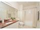 Bright bathroom features a granite-topped vanity, a toilet, and a shower-tub combination at 193 Longview Ave # 203, Celebration, FL 34747