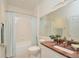 Clean bathroom featuring a marble vanity, a toilet, and a shower with white curtain at 193 Longview Ave # 203, Celebration, FL 34747